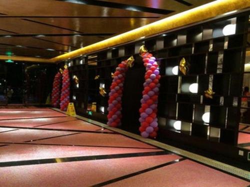 a bowling alley with red and purple balls on the wall at Grand Nest Hotel (Tang Jia Wan Beach) in Zhuhai