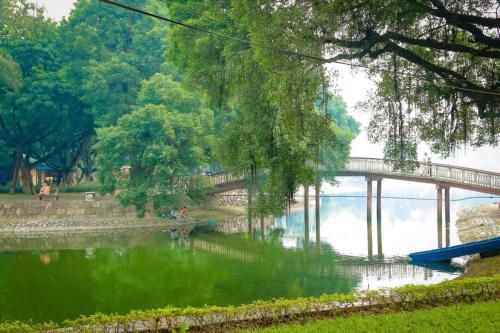 a bridge over a body of water with a river at Ha Noi Vang Hotel Hoang Ngan in Hanoi