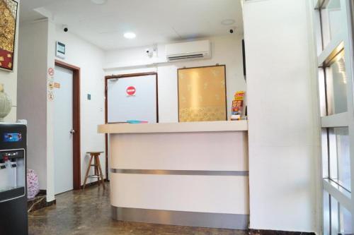 a kitchen with a counter in a room at BudgetOne Hotel in Singapore