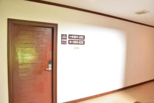 a door in a room with a sign on it at Hungheuang Hotel in Savannakhet
