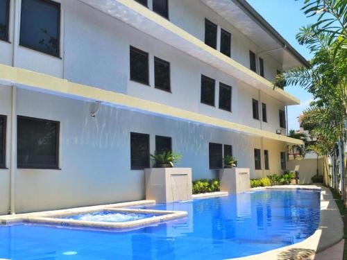 a swimming pool in front of a building at Subic Bay Venezia in Olongapo