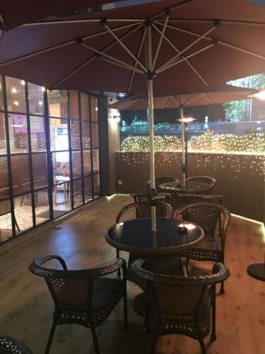 a restaurant with tables and chairs with an umbrella at Harbour Bay Hotel in Hong Kong