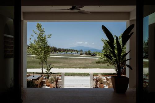 a view from a window of a patio with chairs and plants at Kalani Residence in Keramotí