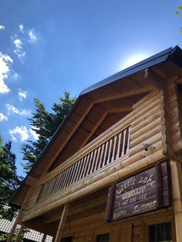 a log cabin with a sign on the side of it at Prokletije Vucetic sobe in Dolja