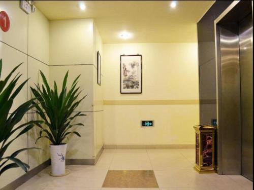 a hallway with a potted plant in a building at Jinjiang Inn Nanjing Xinjiekou in Nanjing