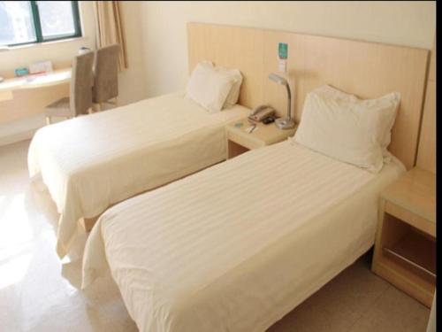 a hotel room with two beds and a telephone at Jinjiang Inn Nanjing Xinjiekou in Nanjing