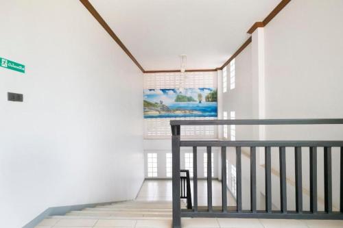 a staircase in a house with a picture on the wall at OYO 732 Juthamas Hotel in Patong Beach