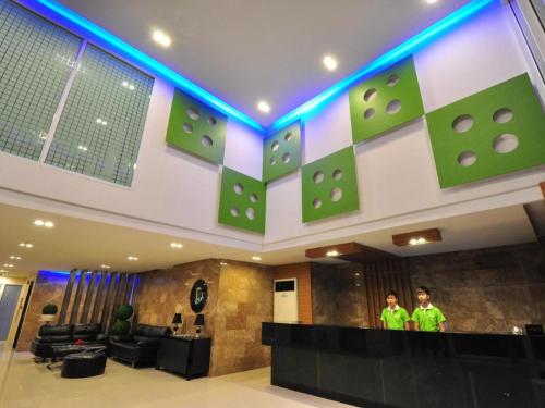 a lobby with two people standing at a counter at Tanzeno Hotel in Nong Khai