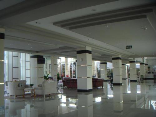 a lobby with couches and chairs in a building at CK Tanjungpinang Hotel and Convention Centre in Tanjung Pinang 