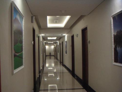 a hallway of a hospital with a person walking down it at CK Tanjungpinang Hotel and Convention Centre in Tanjung Pinang 