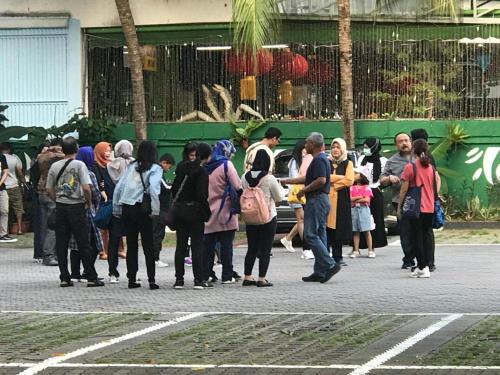 a group of people standing on a street at Lai Ming Hotel Cosmoland in Singapore