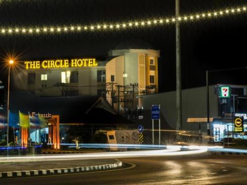 a building with a sign that reads the circle hotel at night at The Circle Hotel in Buriram