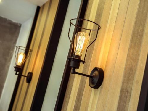 a light on the side of a door at The Circle Hotel in Buriram