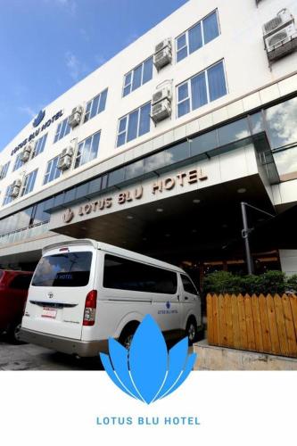 a white van parked in front of a hotel at Lotus Blu Hotel in Legazpi