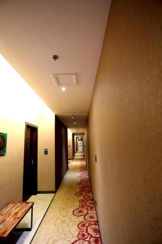 a hallway with a long hallway with a table on the side at Lotus Blu Hotel in Legazpi