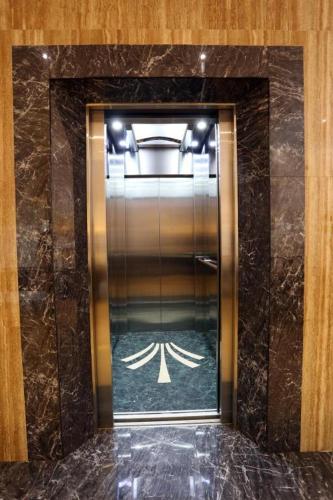 a elevator in a building with a glass door at Lotus Blu Hotel in Legazpi
