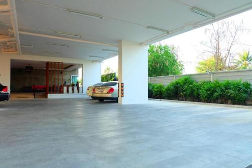a car parked in a parking lot in a garage at The Pride in Nakhon Pathom