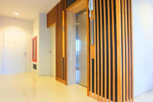 a hallway with a glass door in a building at The Pride in Nakhon Pathom