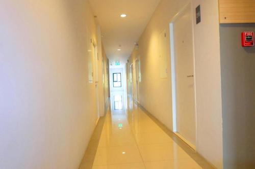 an empty hallway of a building with a hallway at The Pride in Nakhon Pathom