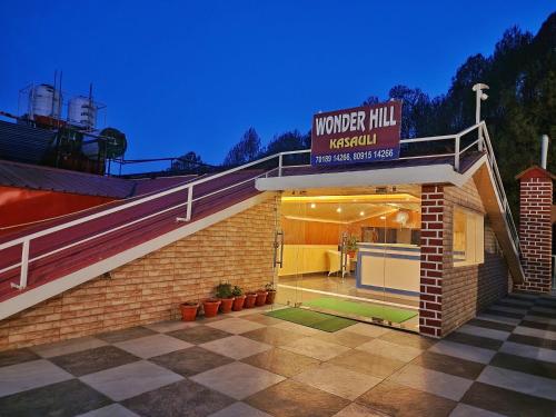 a building with a sign that reads wonder hill hospital at Wonder Hill Kasauli in Kasauli