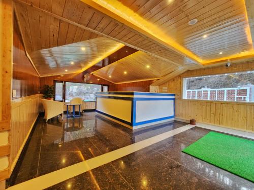 a large room with a large screen in the middle at Wonder Hill Kasauli in Kasauli