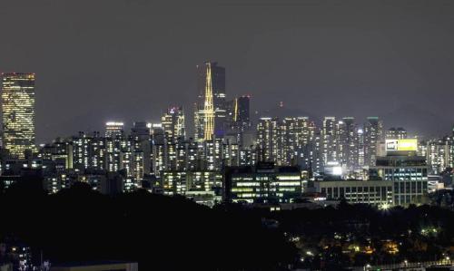 a city skyline at night with lit up buildings at CS Premier Hotel in Seoul