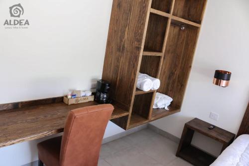 a room with a desk in a hotel room at ALDEA Luxury villas & suites in San Martín de las Pirámides