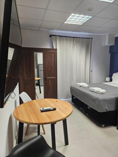 a small room with a bed and a table at DATA Maisonettes and more in Chios