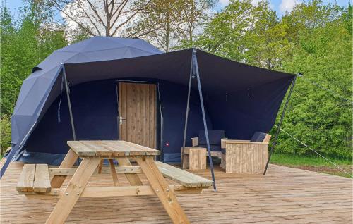 a tent with a picnic table in front of it at Awesome Stacaravan In Hoogersmilde in Hoogersmilde