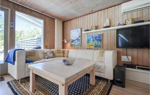 a living room with a couch and a table at Holiday Home Høgevej Kolind Vi in Kolind