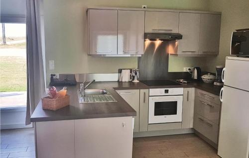 une cuisine avec des armoires blanches et un évier dans l'établissement Amazing Home In Elliant, à Elliant