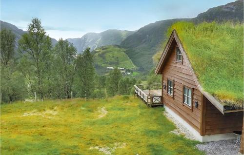 a log cabin with a grass roof on a hill at Five-Bedroom Holiday Home In Vikesa in Hovland