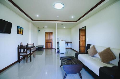 a living room with a couch and a table at AmornSukhothai Hotel in Sukhothai