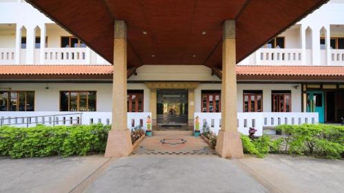 a large white building with a large roof at AmornSukhothai Hotel in Sukhothai