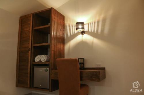 a room with a desk and a shelf and a light at ALDEA Luxury villas & suites in San Martín de las Pirámides