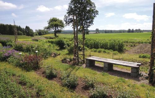 a bench in the middle of a field at Holiday Home Gunnarstorp Vessigebro in Vessigebro