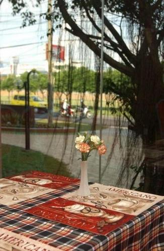 a table with a vase with flowers on it at HOTEL STAR 39 in Ho Chi Minh City
