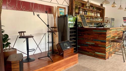 a room with a bar with a counter with wine bottles at Bella Napoli Resort & Resto in Panglao