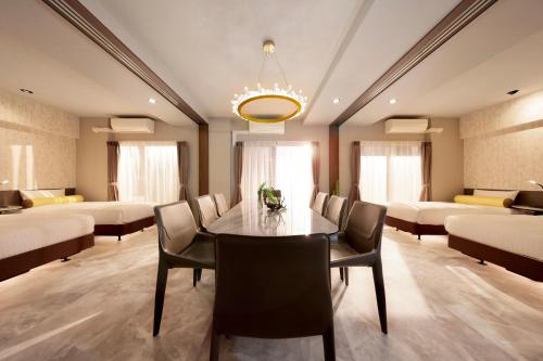 a dining room with a table and chairs at Dotombori Crystal Hotel 3 in Osaka