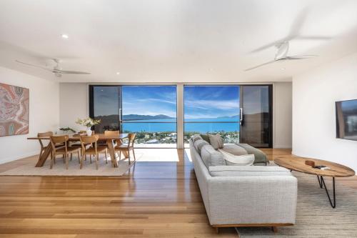 a living room with a couch and a table at Incredible Views, Open Spaces, Luxury Escapes Townsville Villa in Belgian Gardens