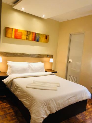 Postel nebo postele na pokoji v ubytování Baguio Holiday Villas