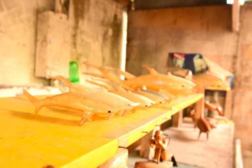 a row of toy sharks sitting on a table at Malapatel in Logon