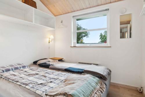 a bedroom with a bed and a window at Luxury House Spasauna, Carcharger, River in Fårvang