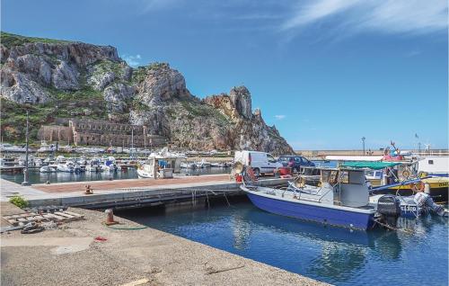 a boat is docked at a dock in the water at Casa Sole Rosso in Buggerru