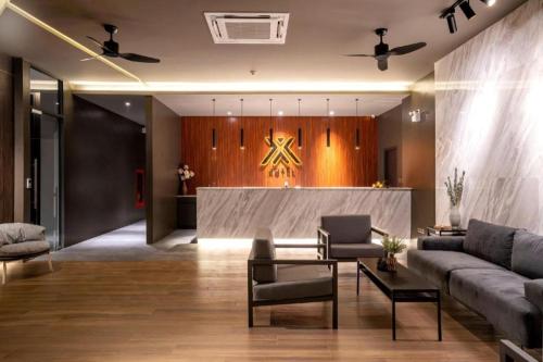 a living room with a couch and a table at XOTEL in Khon Kaen