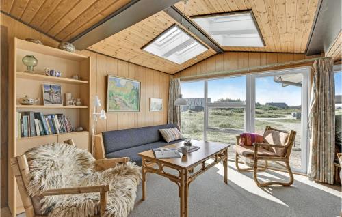 a living room with a couch and a table at Holiday Home Holmsborgvej Ringkøbing X in Søndervig