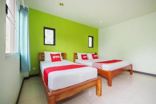 Un ou plusieurs lits dans un hébergement de l'établissement OYO 676 Kradangnga Resort