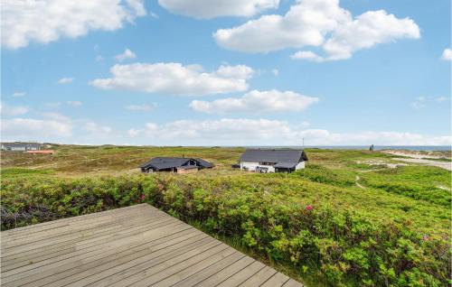 a house on the beach with a wooden deck at 4 Bedroom Stunning Home In Thisted in Thisted