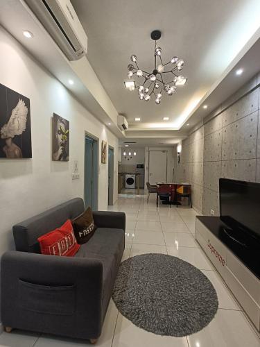 een woonkamer met een bank en een televisie bij SS Homestay in Kota Kinabalu