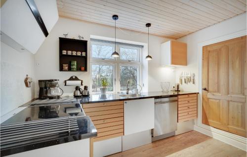 a kitchen with white walls and a wooden ceiling at 3 Bedroom Gorgeous Home In Lem St in Karsbæk